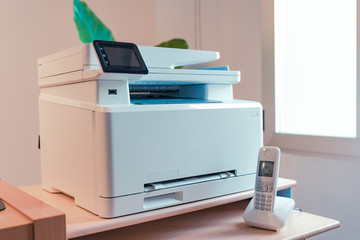 White Multi function color laser printer and wireless phone terminal. Office devices. WiFi laser...