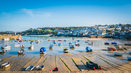 Fishing boats during low tide in the evening at sunset at the harbor of St Ives vacation, fishing...