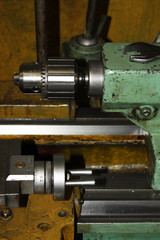 Professional lathe machine in a workshop. Part of the lathe close-up. The metal of the industrial lathe in a metalworking factory
