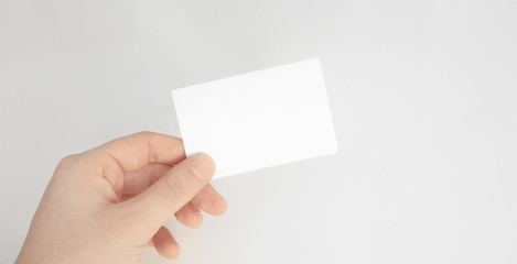 Person hand holding blank paper card isolated white background