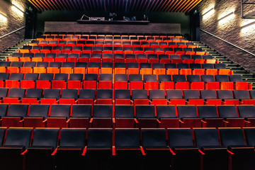 Empty public theatre or cinema auditorium hall with rows of seats or chairs