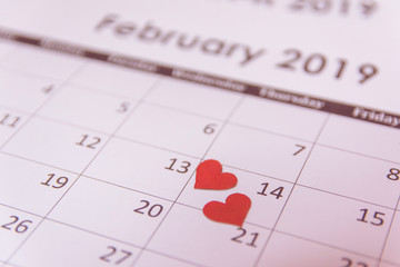 Valentines day greeting card. Red hearts paper on Calendar page February 14 with copy space