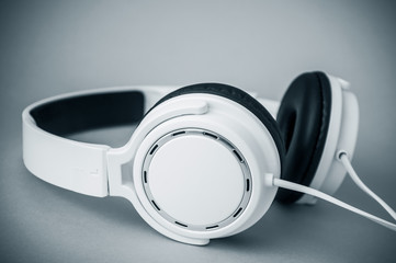 closeup of white headphones on black and white