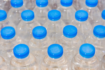 Row of water bottles. Bottles with blue caps For drinking water