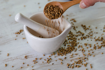 Coriander seed pounding in mortar prepare for  food cooking