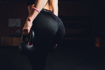 Sexy beautiful ass in thong. Fitness girl, athletic woman working out with dumbbells.
