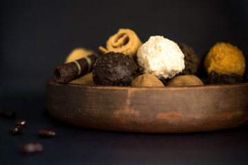 Preparation for a banner with sweets. Photo of chocolate candies and waffles on a blue background with a place for copispeys. Photos of chocolates and sweets. Frame for a card with sweets