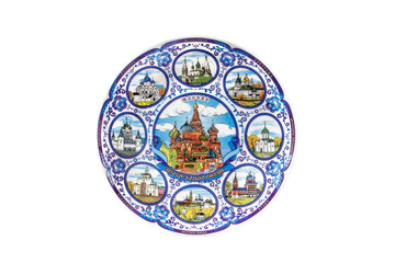 ceramic souvenir toy in the form of plate with color painting on isolated white background reflecting the national Russian culture with the inscription in Russian: The Golden ring of Russia Moscow