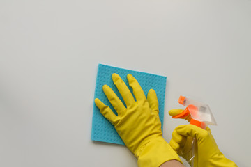 Woman hands with cleaning equipment on white background