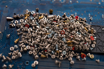 Bolts and screws for repair on the electronic board. Computer components. Close-up.