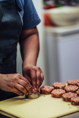 Female Chef Making Round Pork Cutlet for Some Burgers for Wedding Meal