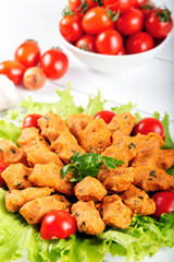 Traditional mercimek koftesi, lentil patties served with lettuce and tomato.