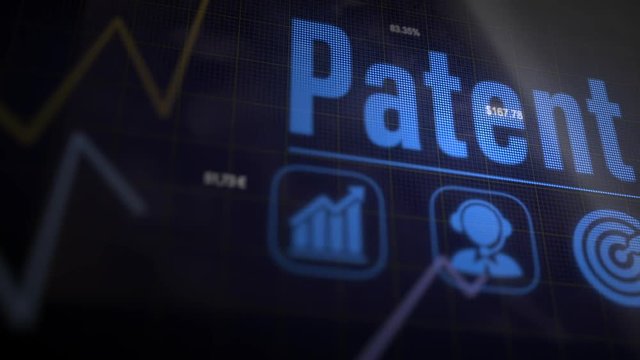 Patent business concept on a flashing computer monitor with moving graphs and data.