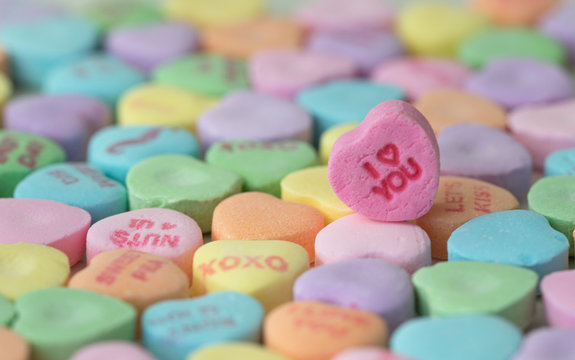 Valentine photo of colored candy hearts laid out with I love you