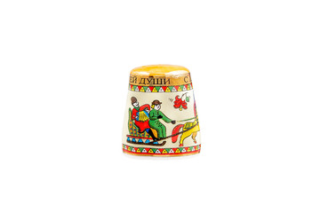 Fototapeta na wymiar ceramic souvenir toy in the form of thimble with beautiful color painting on isolated white background reflecting the national Russian culture with the inscription in Russian: 