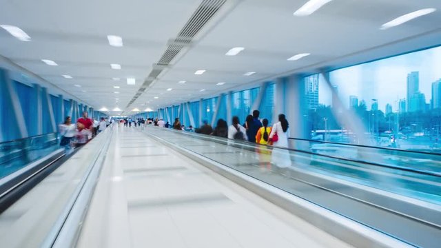 Tourists And Residents Of The City Of Dubai Are Moving Along A Pedestrian Crossing. The Transition From The Metro Station To The Shopping And Entertainment Center Dubai Mall. Video Hyper Lapse