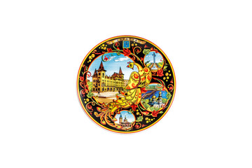 ceramic souvenir toy in the form of plate with color painting on isolated white background reflecting the national Russian culture with the inscription in Russian: the name of the city of Saratov
