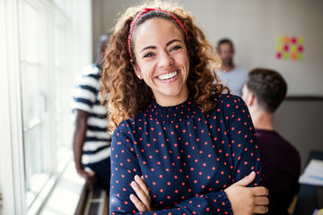 Fototapeta Smiling female designer standing in an modern office obraz