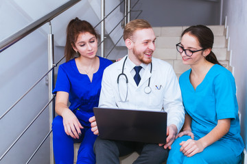 healthcare. A group of student medical students communicates in front of a laptop. Discussion of...