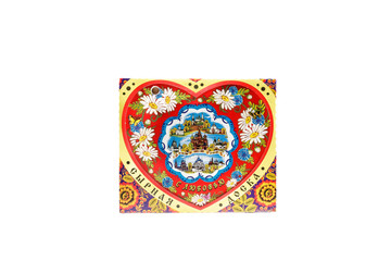 ceramic souvenir toy in the form of heart with beautiful color painting on isolated white background reflecting the national Russian culture with the inscription in Russian: Cheese Board With love