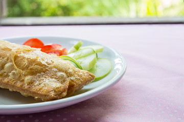 Corn pie with dish on table.