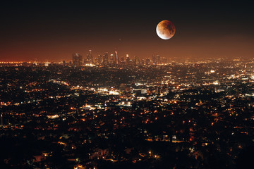 Beautiful night aerial view of Los Angeles, California, USA, with downtown district and a full moon...
