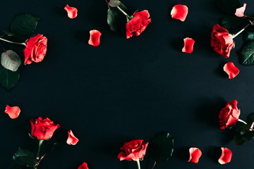 Flowers composition. Red roses on black background. Flat lay, top view, copy space
