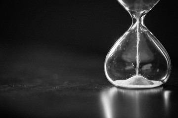Hourglass as time passing concept for business deadline, urgency and running out of time....