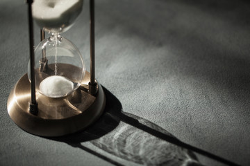 Hourglass as time passing concept for business deadline, urgency and running out of time....