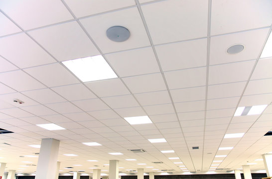 White office ceiling with white tiles and lighting