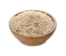 Wooden bowl with brown rice on white background