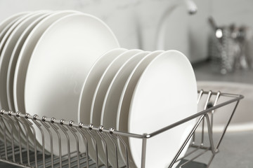 Drying rack with clean dishes on kitchen counter