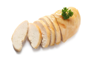 Partially cut fried chicken breast with parsley on white background