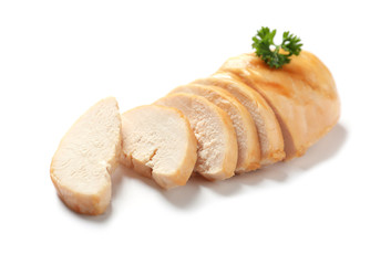 Partially cut fried chicken breast with parsley on white background