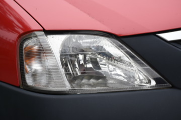 shiny headlights on a red car