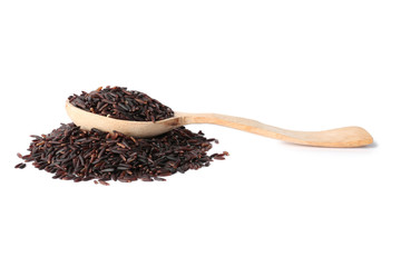 Spoon and uncooked black rice on white background