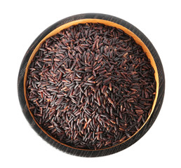 Plate with uncooked black rice on white background, top view