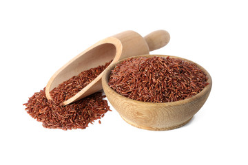 Bowl and scoop with uncooked brown rice on white background