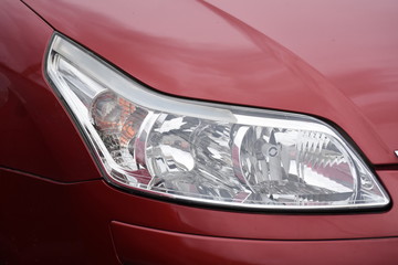 shiny headlights on a  red car