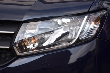 shiny headlights on a blue  car