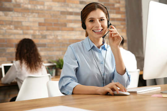 Technical support operator with headset at workplace