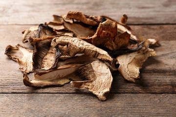 Delicious dried mushrooms on wooden background, closeup