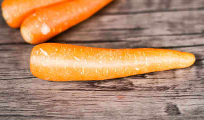 Fresh carrots on wood background.