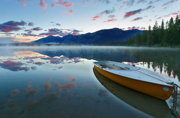 Beautiful sunset over Edith Lake with  colorful boats in foreground, Jasper National Park, Alberta, Canada