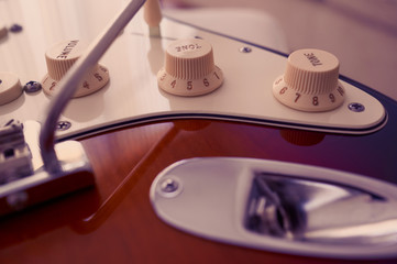 Close-up of electric guitar, at sunny living room