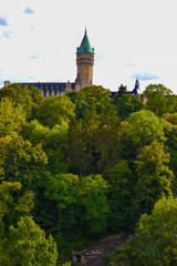 Vertical picture of Musée de la Banque in Luxembourg City, Luxembourg, with green trees at the foreground