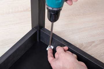 the process of furniture assembly screwdriver closeup