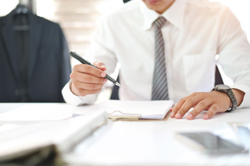 Cropped shot of businessman signing contract making a deal on office workplace.