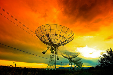 The silhouette of a radio telescope observatory