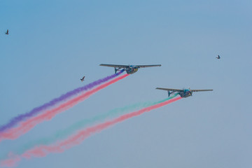 Army show performant air craft and colorful smoke in air show with blue cloud sky background.